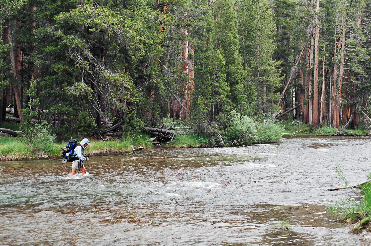 A fellow thru-hiker fording a wide stream.